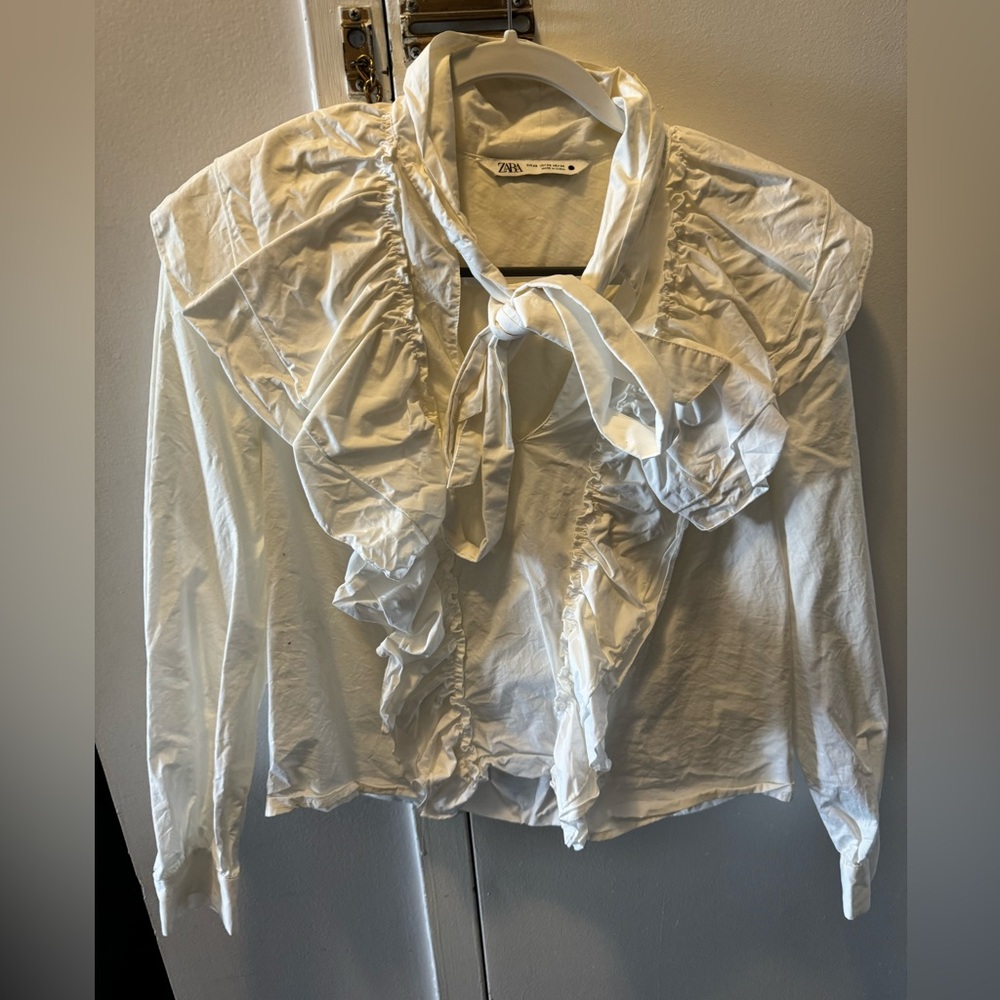 White ruffled blouse with tie neck detail